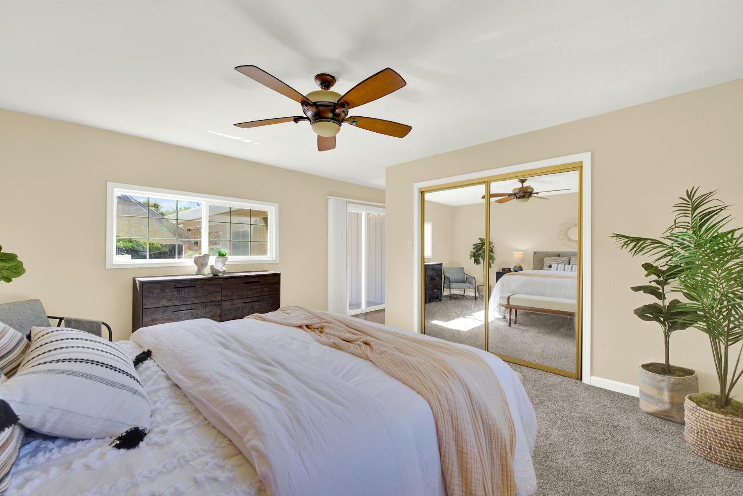 19858 Road 94C Woodland, CA 95695 - Photo 45 of 85 a bedroom with a large bed and a potted plant