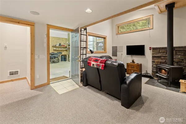 a living room with furniture a flat screen tv and a floor to ceiling window