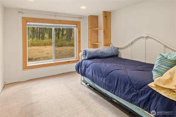 a bedroom with a bed and window