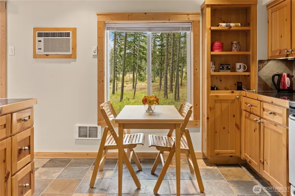 a dining room with furniture and a window