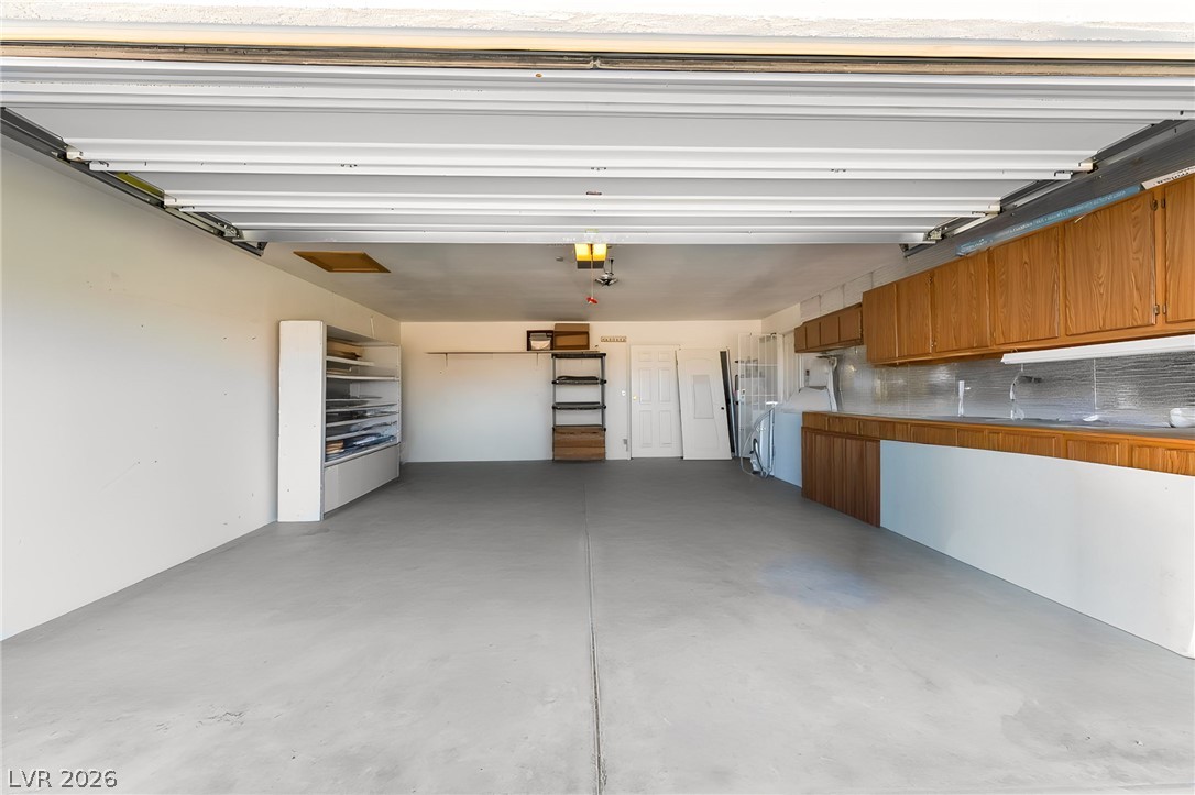 3631 South Blagg Road Pahrump, NV 89048 - Photo 33 of 47 Ample garage space with built-in cabinetry provides versatile storage and utility.