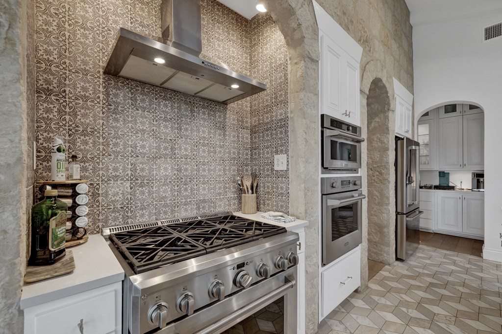 2975 Bear Creek Road Fredericksburg, TX 78624 - Photo 12 of 53 a stove top oven sitting inside of a kitchen