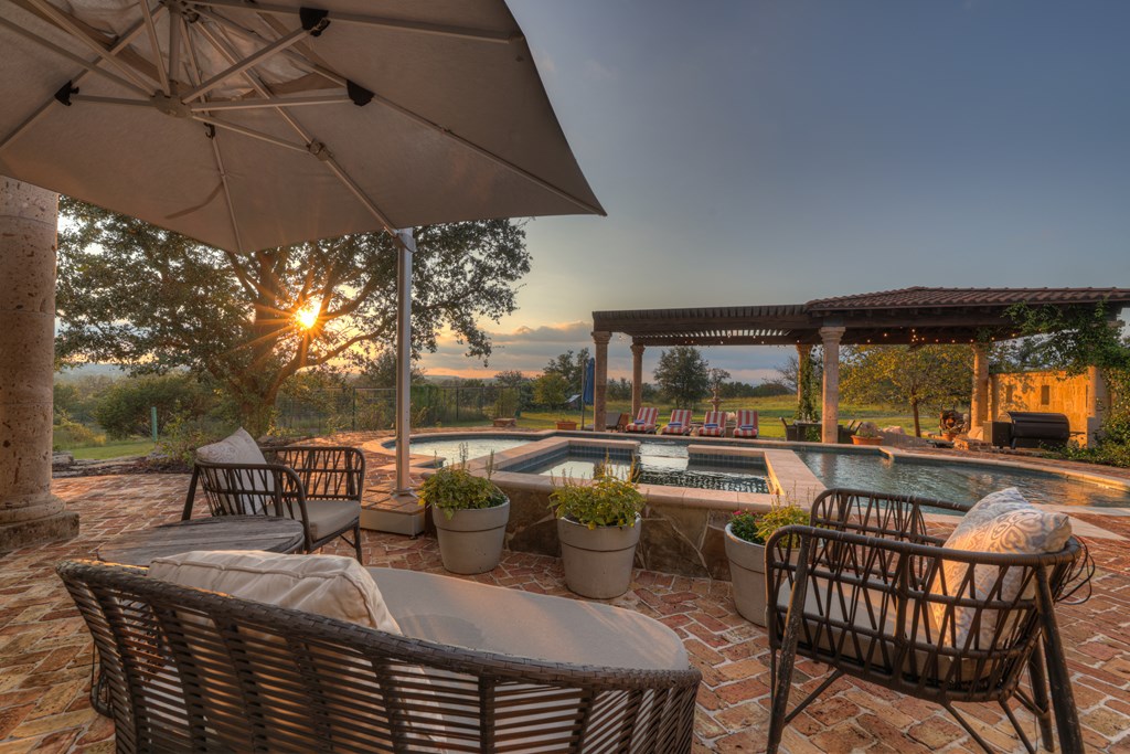2975 Bear Creek Road Fredericksburg, TX 78624 - Photo 22 of 53 a view of a patio with table and chairs under an umbrella
