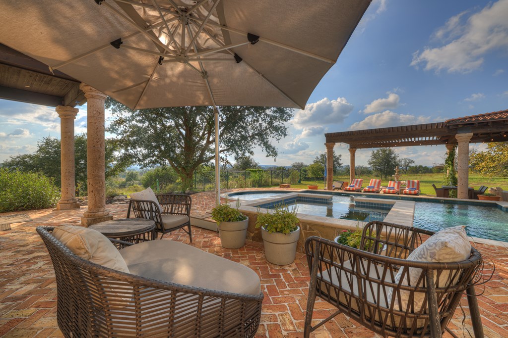 2975 Bear Creek Road Fredericksburg, TX 78624 - Photo 30 of 53 a view of a patio with a table and chairs