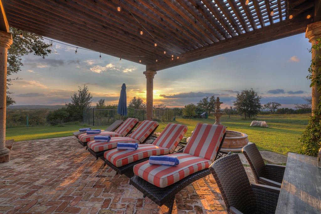 2975 Bear Creek Road Fredericksburg, TX 78624 - Photo 44 of 53 a outdoor sitting area with furniture and wooden floor