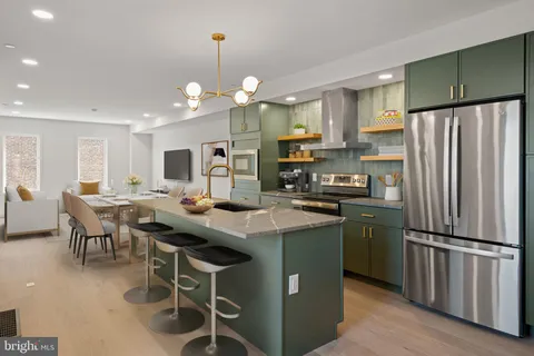 a kitchen with stainless steel appliances granite countertop a refrigerator a sink dishwasher a stove and a refrigerator