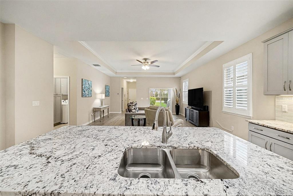 14902 Caravan Avenue Odessa, FL 33556 - Photo 17 of 40 a kitchen with granite countertop a sink and a stove top oven