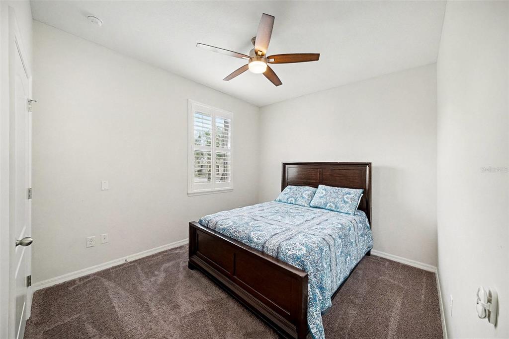 14902 Caravan Avenue Odessa, FL 33556 - Photo 23 of 40 a bedroom with a bed and window