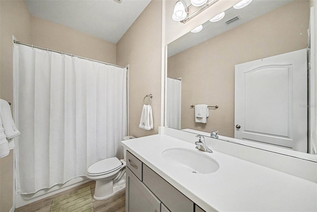14902 Caravan Avenue Odessa, FL 33556 - Photo 24 of 40 a bathroom with a sink a toilet and a mirror