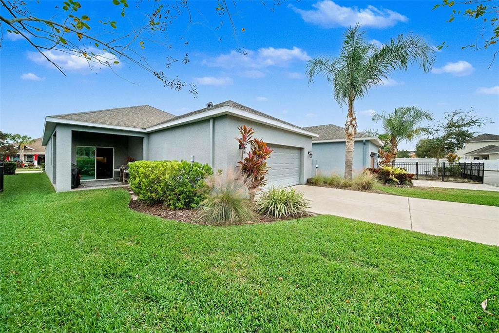 14902 Caravan Avenue Odessa, FL 33556 - Photo 27 of 40 a front view of a house with a yard and garage