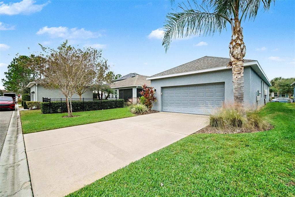 14902 Caravan Avenue Odessa, FL 33556 - Photo 29 of 40 a front view of a house with a yard and garage