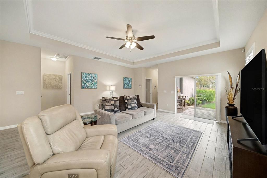 14902 Caravan Avenue Odessa, FL 33556 - Photo 8 of 40 a living room with furniture flat screen tv and a large window