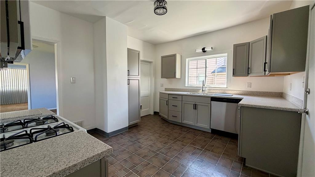 641 Garfield Street Springdale, PA 15144 - Photo 12 of 44 a kitchen with a sink stove and cabinets