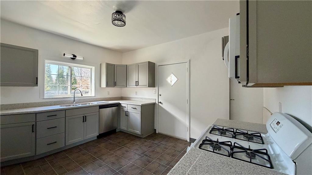 641 Garfield Street Springdale, PA 15144 - Photo 14 of 44 a kitchen with sink cabinets and stove top oven