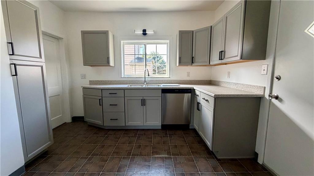 641 Garfield Street Springdale, PA 15144 - Photo 15 of 44 a kitchen with a sink window and cabinets