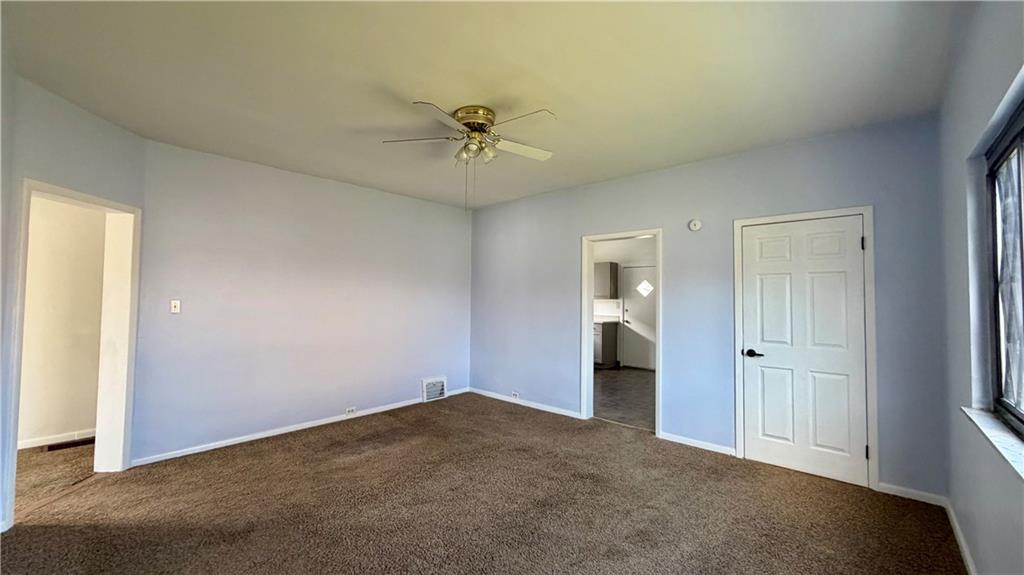 641 Garfield Street Springdale, PA 15144 - Photo 9 of 44 an empty room with closet and a chandelier fan
