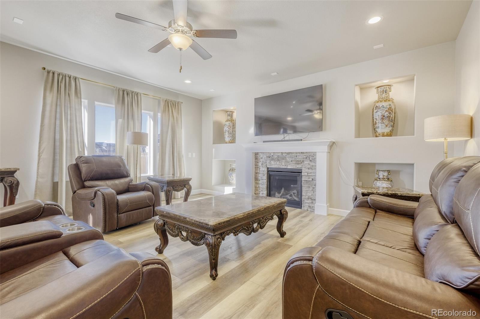 9093 Peaceful Valley Road Colorado Springs, CO 80925 - Photo 11 of 42 a living room with furniture and a fireplace