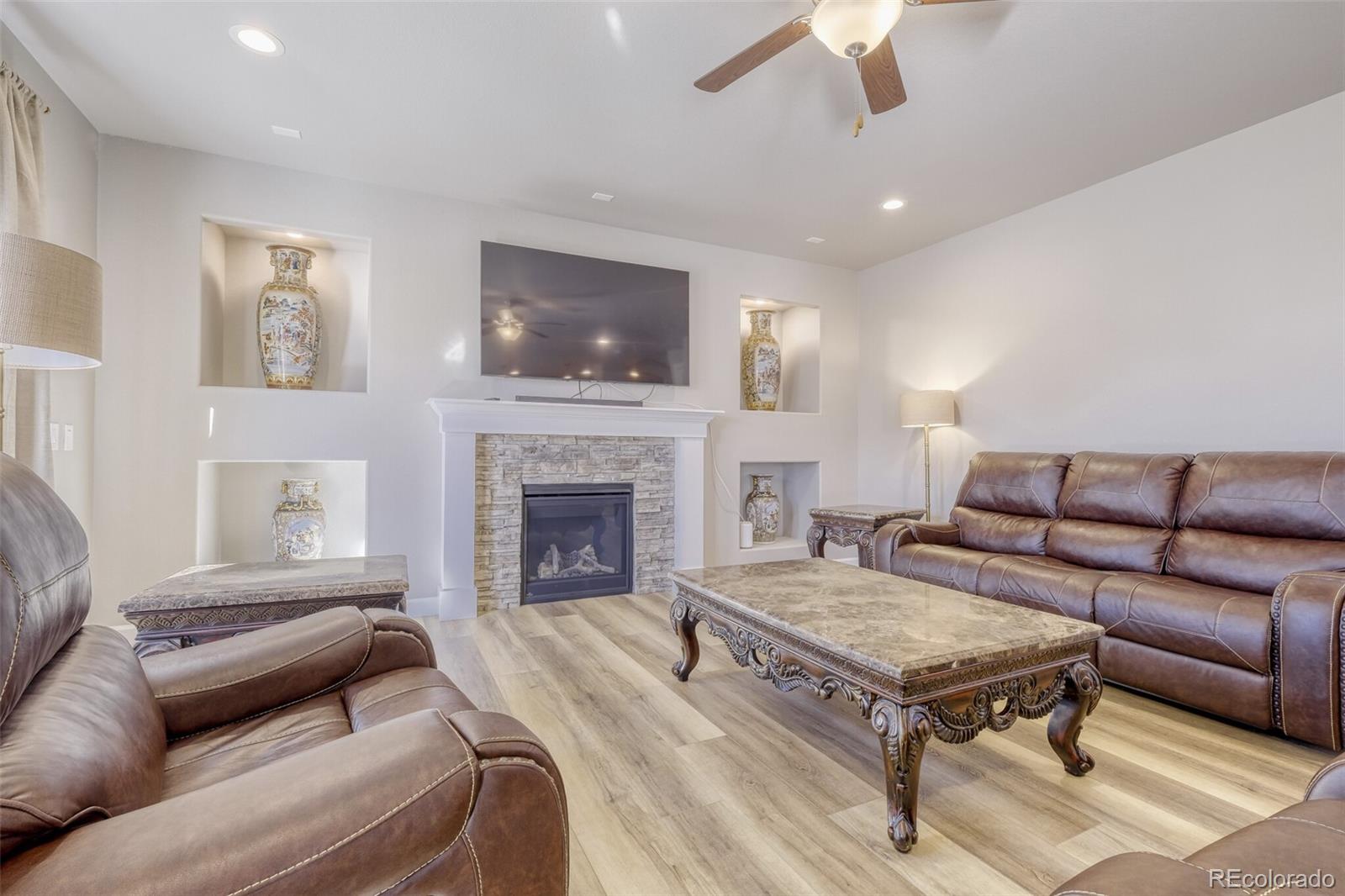9093 Peaceful Valley Road Colorado Springs, CO 80925 - Photo 12 of 42 a living room with furniture and a fireplace