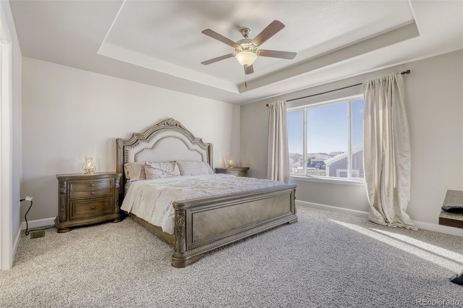 9093 Peaceful Valley Road Colorado Springs, CO 80925 - Photo 18 of 42 a bedroom with a bed and a window