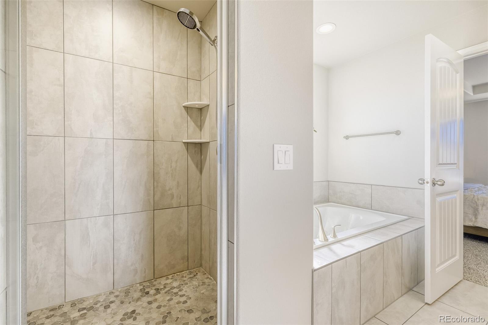 9093 Peaceful Valley Road Colorado Springs, CO 80925 - Photo 22 of 42 a bathroom with a bathtub