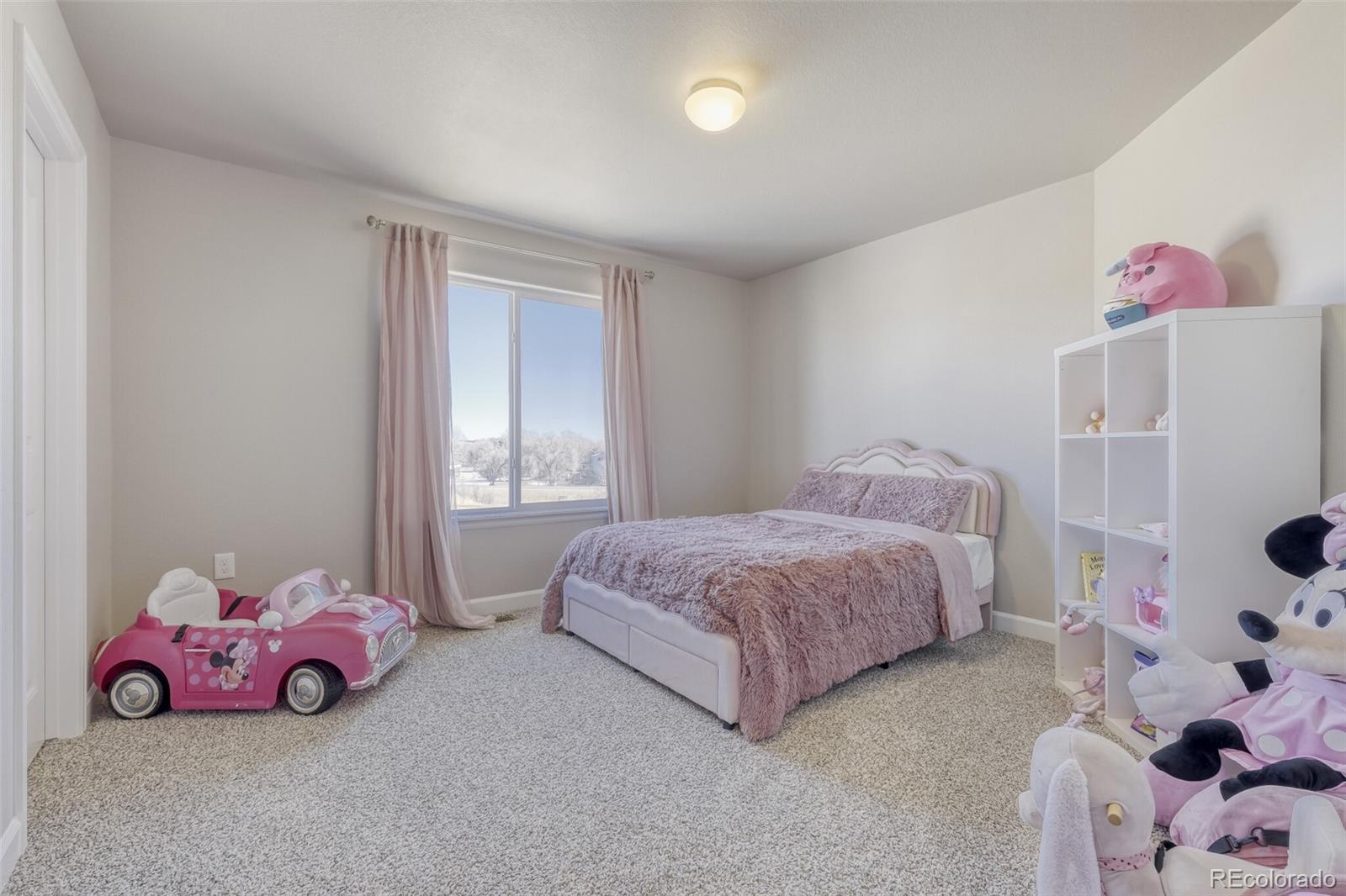 9093 Peaceful Valley Road Colorado Springs, CO 80925 - Photo 27 of 42 a bedroom with a bed and a window