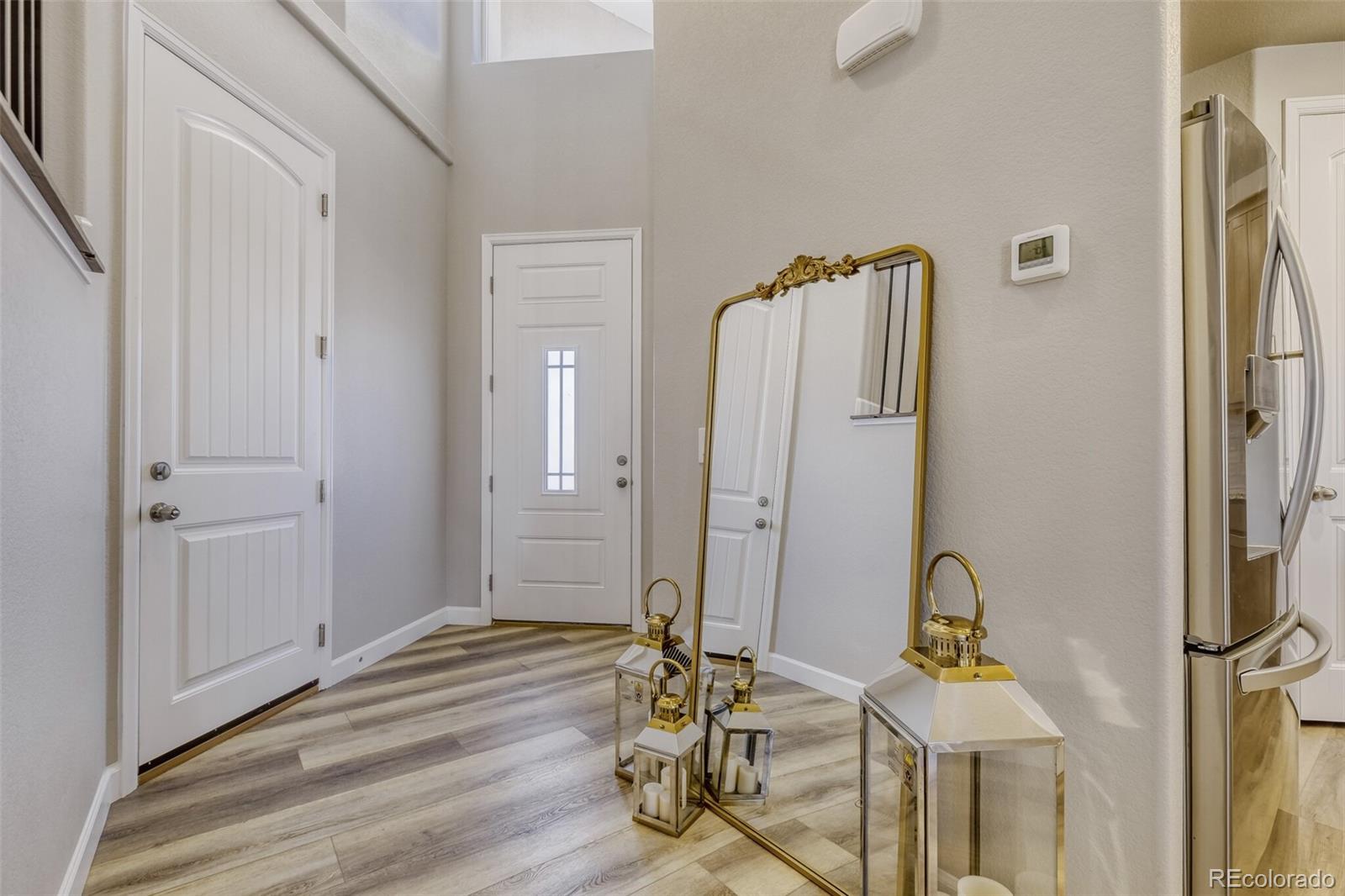 9093 Peaceful Valley Road Colorado Springs, CO 80925 - Photo 5 of 42 a view of a room with wooden floor and white walls