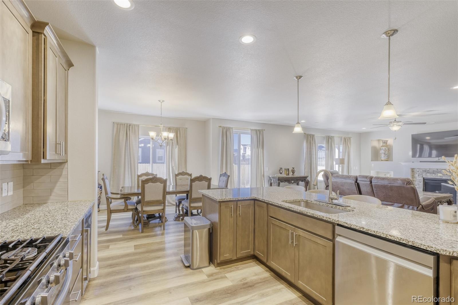 9093 Peaceful Valley Road Colorado Springs, CO 80925 - Photo 9 of 42 a large kitchen with lots of counter space a sink and living room view