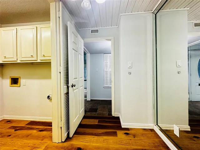 a view of a livingroom with wooden floor and a sink