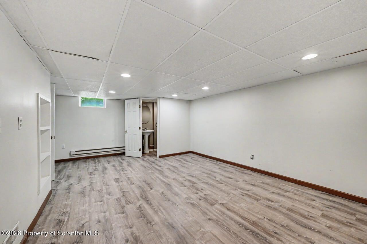 457 Craig Road Dalton, PA 18414 - Photo 97 of 114 an empty room with wooden floor and windows