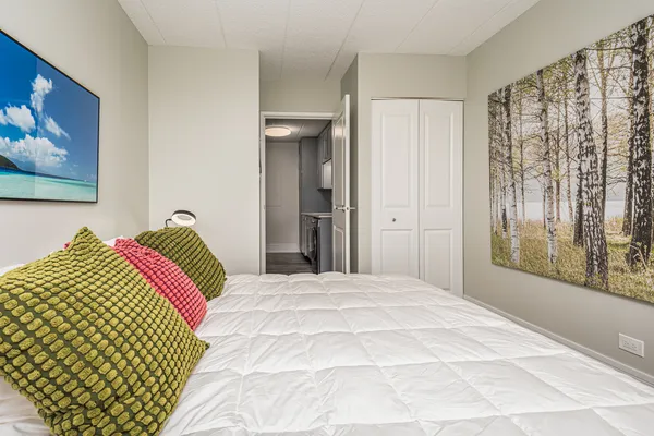 a bedroom with a bed and a large mirror