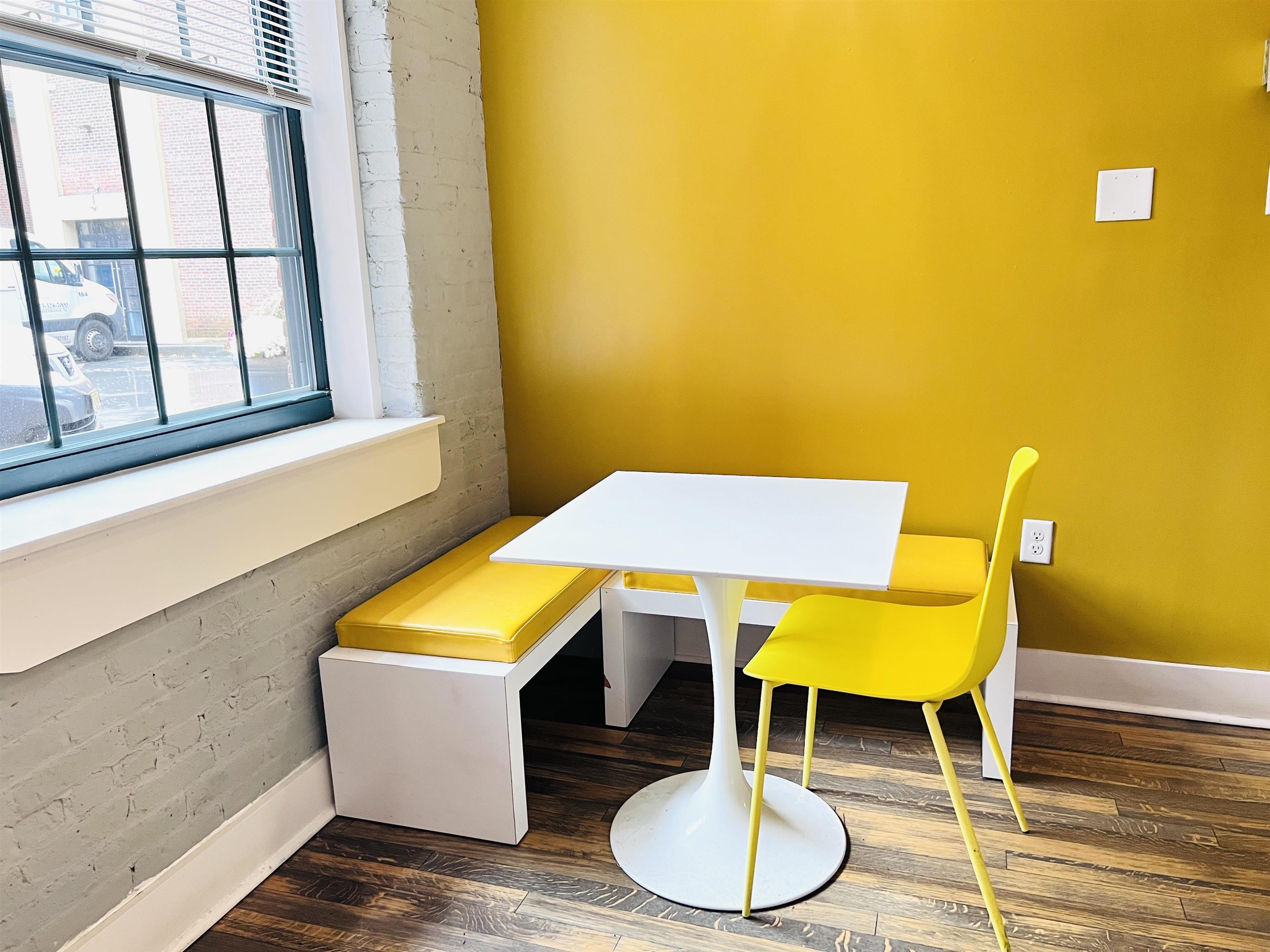 160 Lafayette Street, Unit 52306 Jersey City, NJ 07304 - Photo 23 of 25 a room with table chairs and a wooden floor