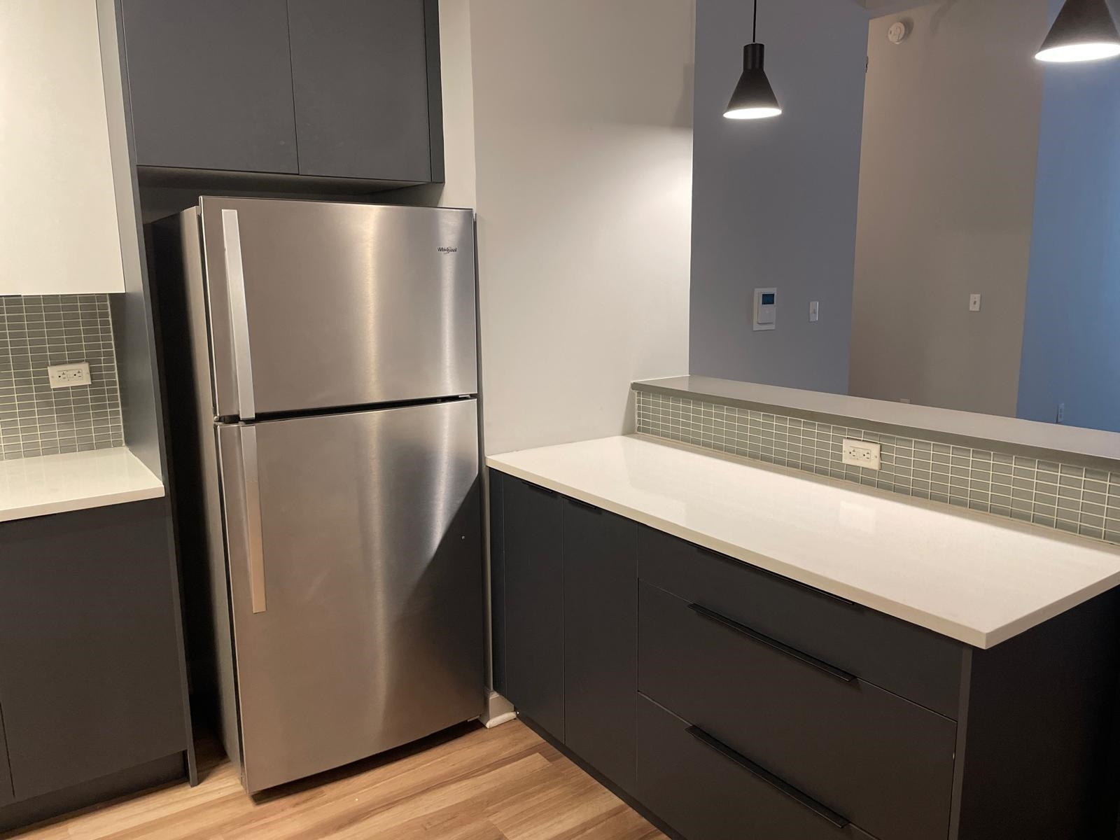 160 Lafayette Street, Unit 52306 Jersey City, NJ 07304 - Photo 8 of 25 a kitchen with a refrigerator and a sink