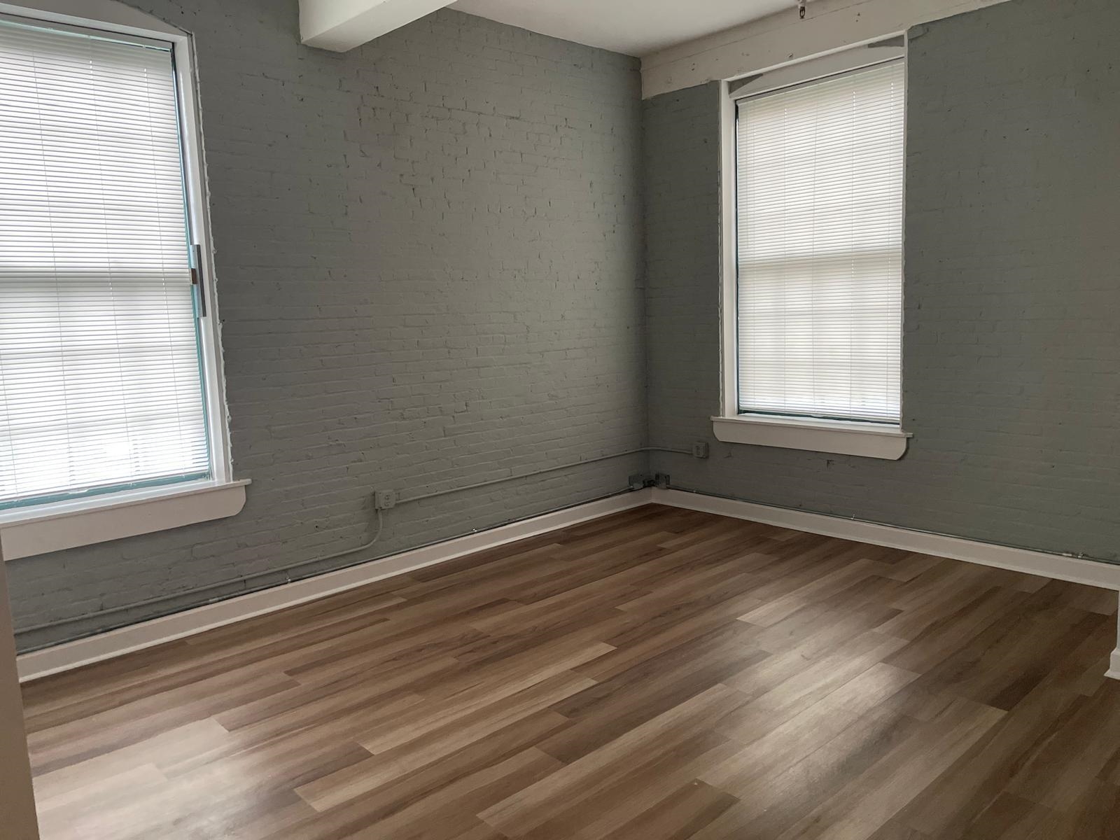 160 Lafayette Street, Unit 52306 Jersey City, NJ 07304 - Photo 10 of 25 an empty room with wooden floor and windows