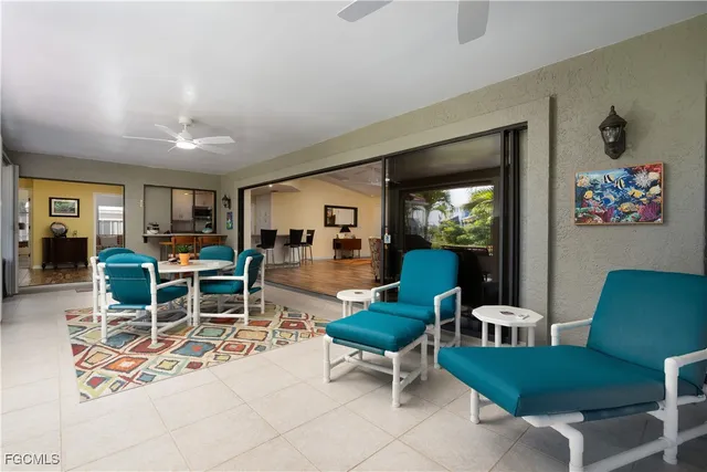 a living room with furniture a rug and a large window