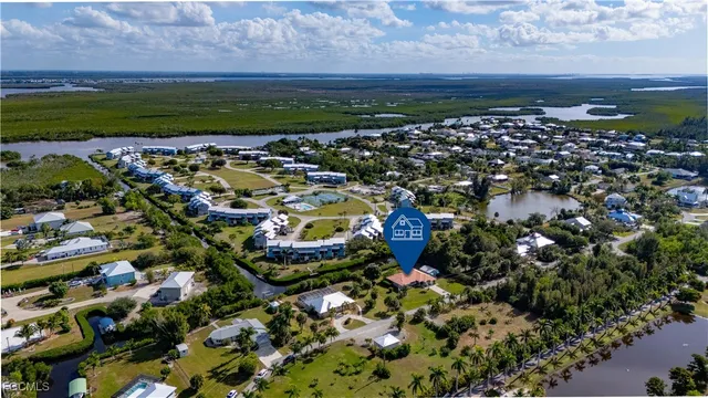 a front view of a house with a yard and potted plants