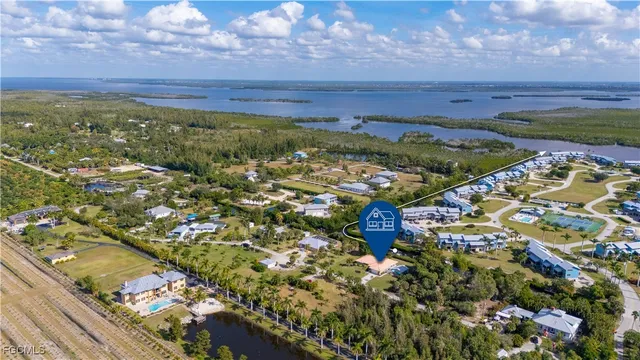 a view of a yard with an tree and a fence
