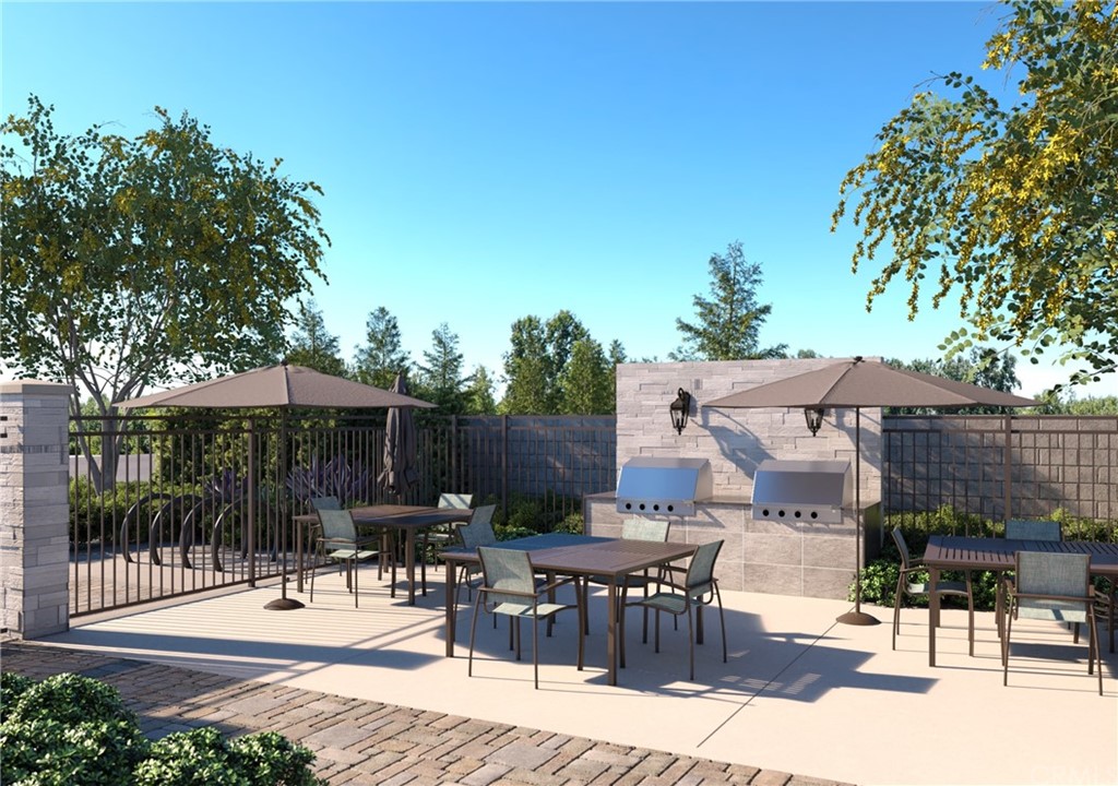 a view of a patio with a dining table and chairs with a fire pit