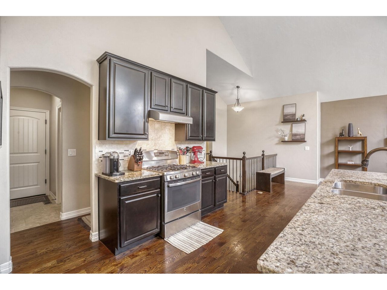 7992 St Street Frederick, CO 80530 - Photo 11 of 28 a kitchen with stainless steel appliances granite countertop a stove top oven a sink a dining table and chairs