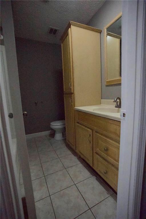 3091 Mustang Drive Columbus, GA 31909 - Photo 13 of 18 a bathroom with a sink a toilet and a mirror