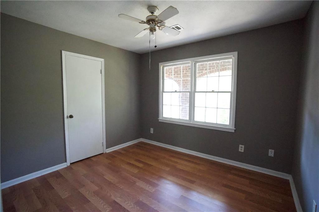 3091 Mustang Drive Columbus, GA 31909 - Photo 14 of 18 a view of empty room with wooden floor and fan