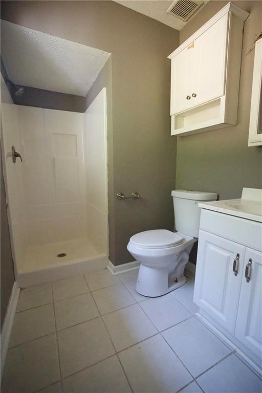 3091 Mustang Drive Columbus, GA 31909 - Photo 16 of 18 a white toilet sitting next to a bathroom sink