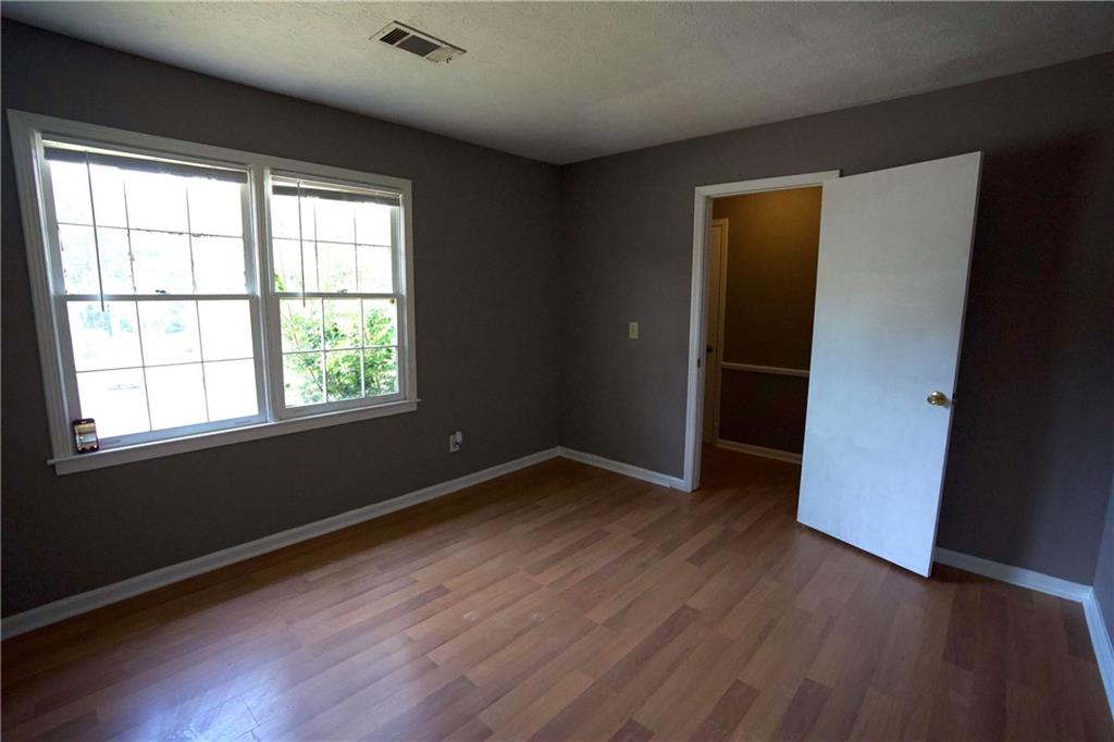 3091 Mustang Drive Columbus, GA 31909 - Photo 5 of 18 an empty room with wooden floor and windows