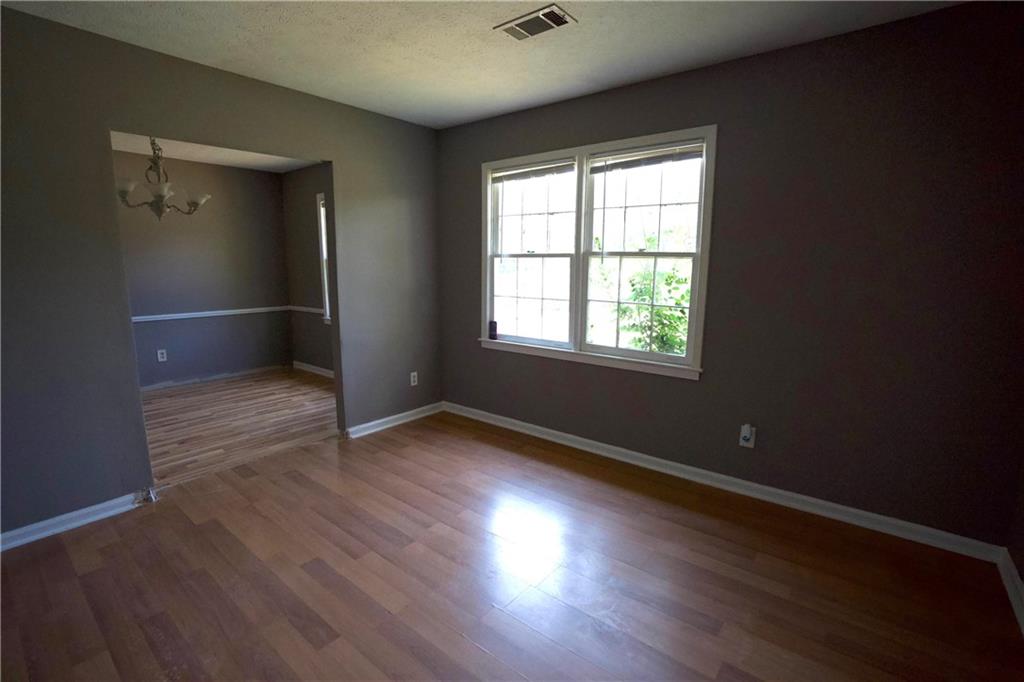 3091 Mustang Drive Columbus, GA 31909 - Photo 6 of 18 an empty room with wooden floor and windows