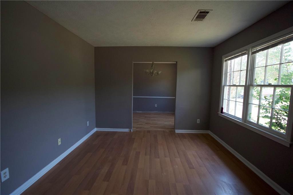 3091 Mustang Drive Columbus, GA 31909 - Photo 7 of 18 an empty room with wooden floor and windows