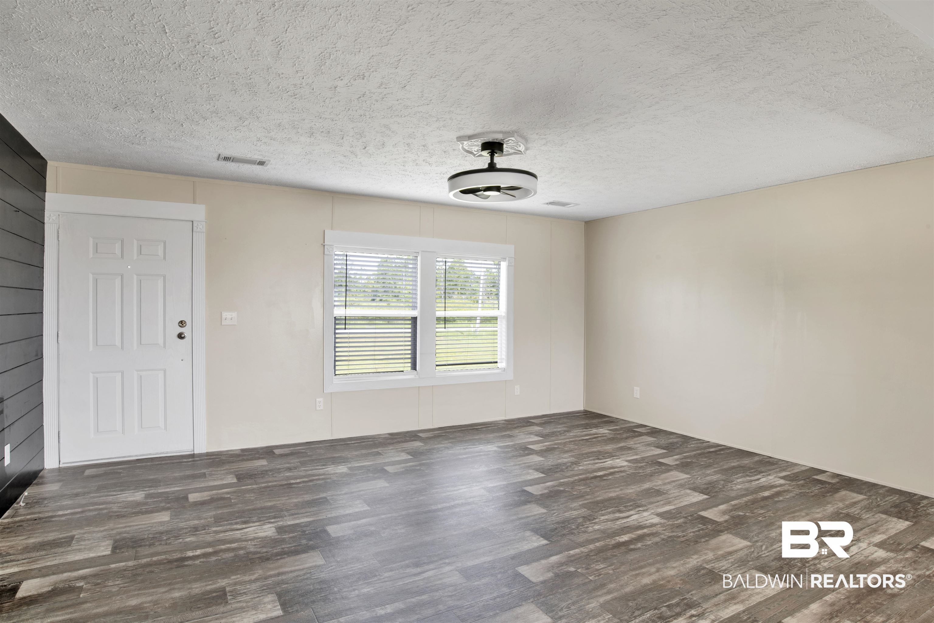 16778 County Road 87 Elberta, AL 36530 - Photo 10 of 32 Empty room with hardwood / wood-style flooring and a textured ceiling