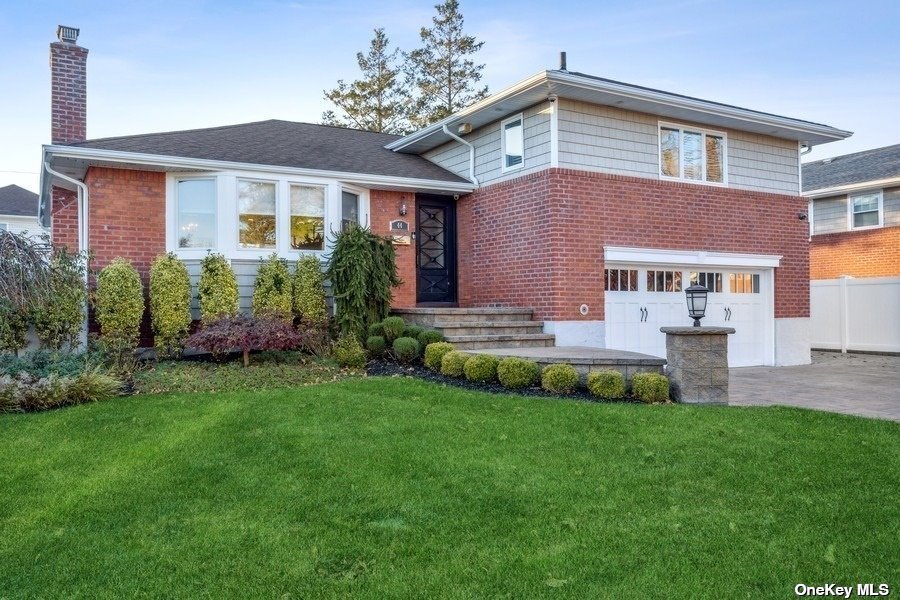 44 Stuart Drive Syosset, NY 11791 - Photo 1 of 1 a front view of a house with a garden and plants