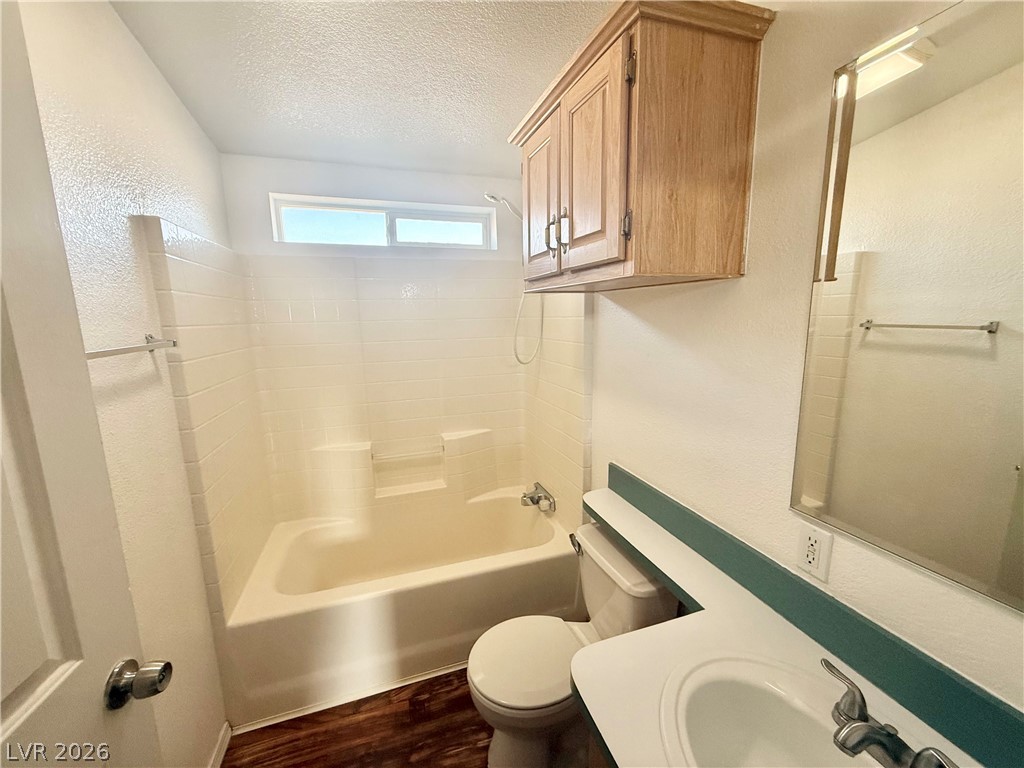6450 Vicki Ann Road Pahrump, NV 89048 - Photo 9 of 9 A well-lit bathroom provides a functional tub and shower combination with ample vanity space.