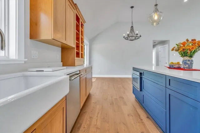 a kitchen with a sink a counter space cabinets and appliances