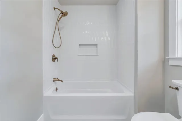 a bathroom with a shower and a toilet