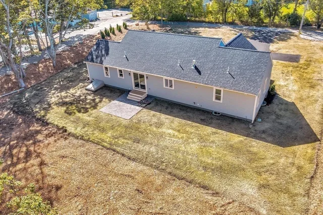 a aerial view of a house with a yard